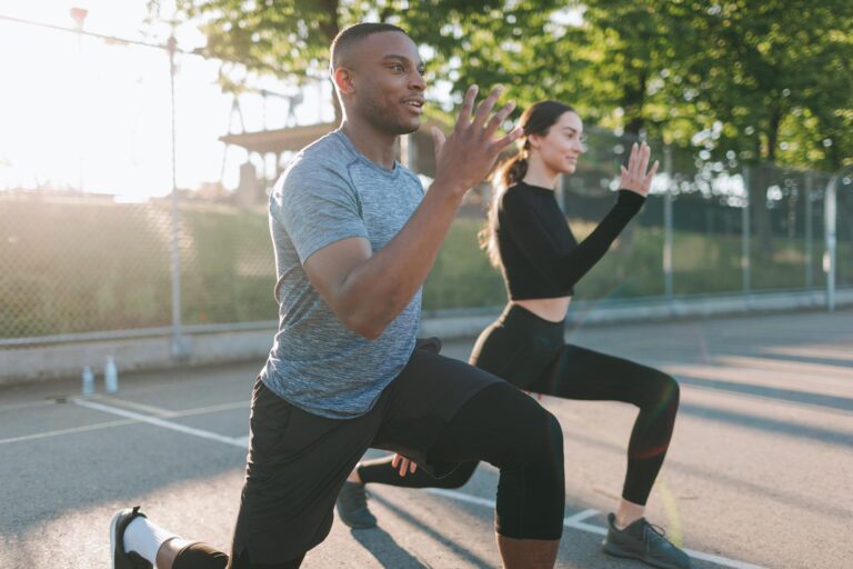 Athletic-Couple-Exercising-Stretching-Outside
